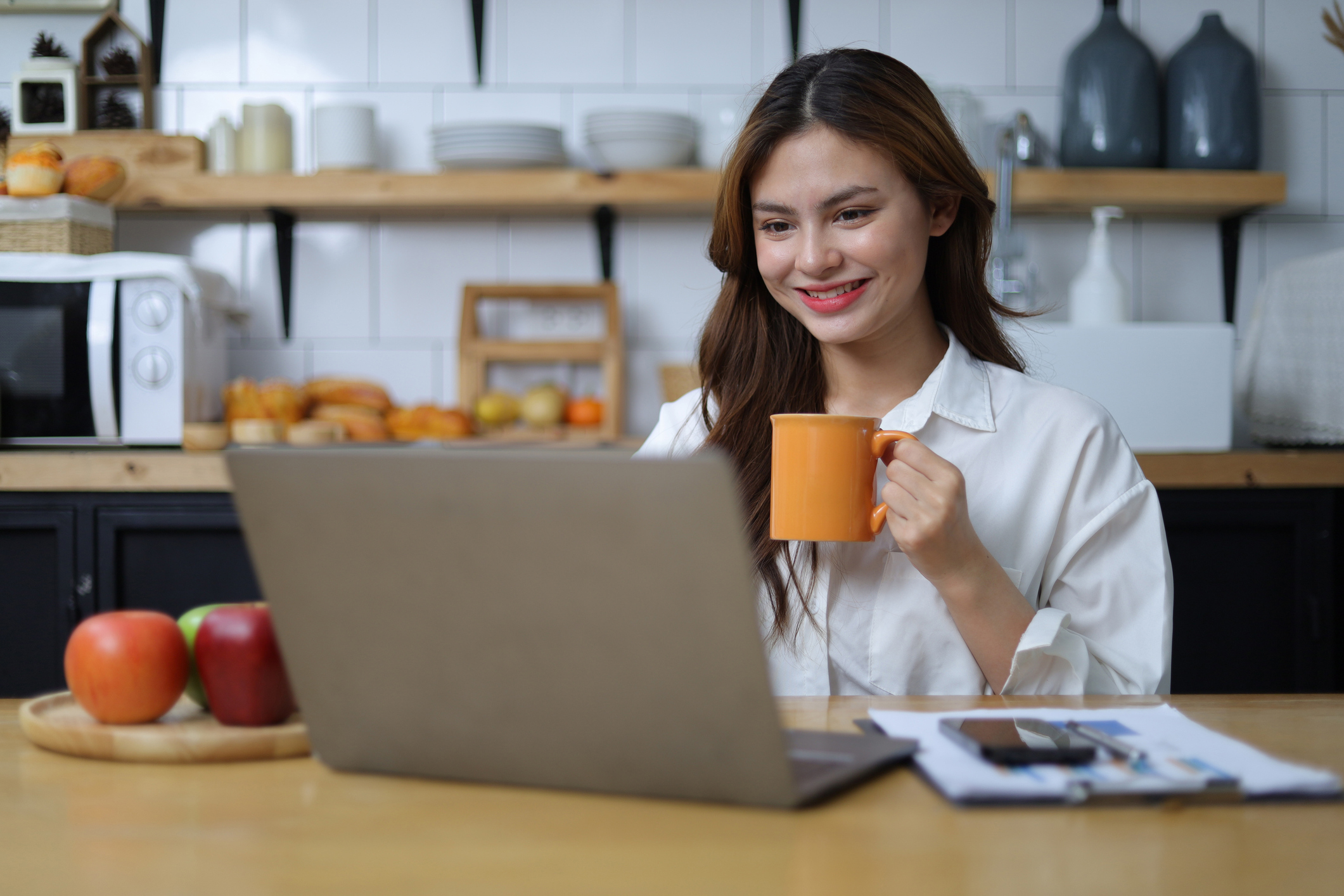 Happy woman working with laptop at home. 